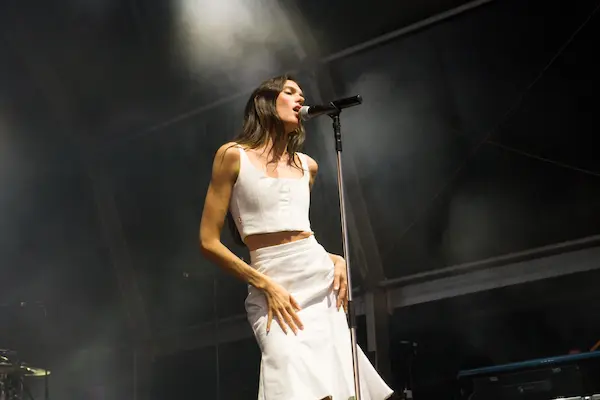 Charlotte Cardin performing live on stage under concert lights