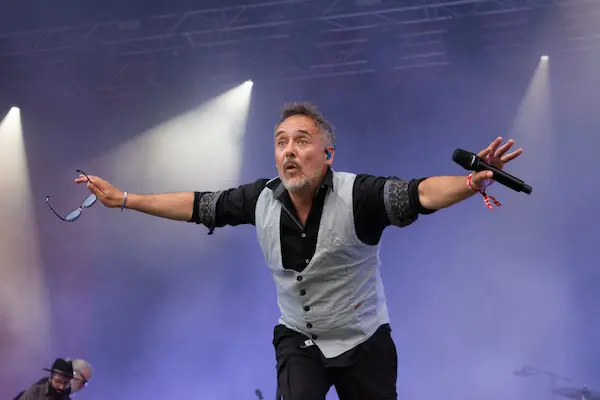 Love of Lesbian band members performing live on stage during a concert